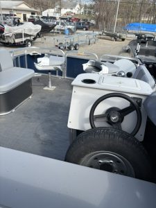 Interior view of the Paddle King LoPro Cruiser boat with steering wheel and seating.