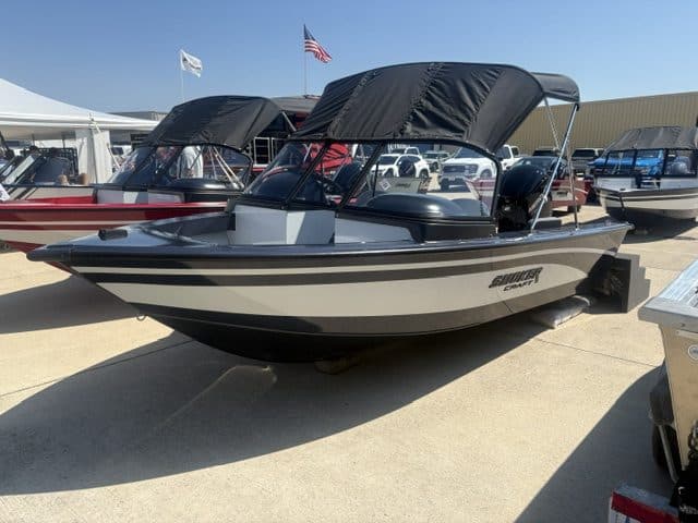 Beneteau Flyer bowrider boat with canopy at marina.