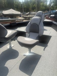 Comfortable boat seat on a fishing boat with other boats in background.