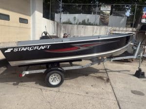 Black Starcraft Seafarer boat on trailer for sale at Camp & Cruise.