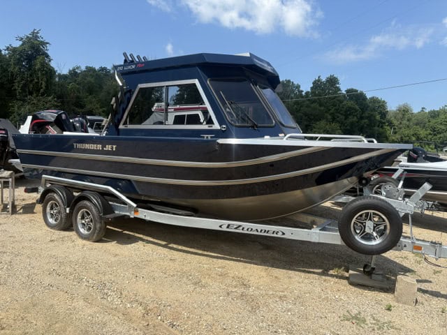 Luxury Thunder Jet 210 Luxor Pro boat on trailer at dealership.