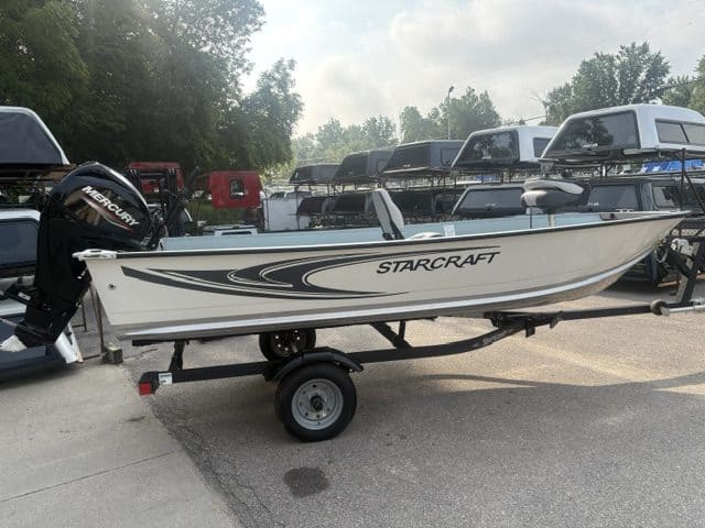 Starcraft Patriot 16 Tiller boat on trailer at Camp & Cruise.