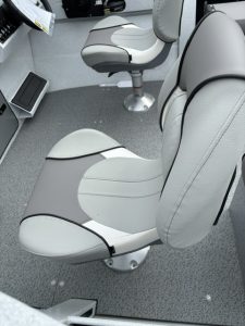 Comfortable boat seats with control panel in a marine vessel.