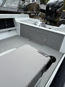 Close-up of boat interior with seating and storage compartments.
