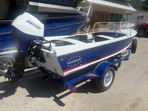 Blue and white Starcraft Ski Champ boat on trailer for sale.