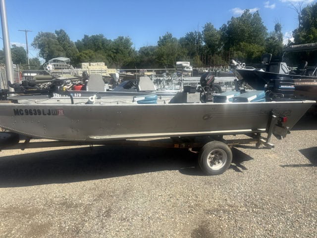 16-foot Sea Nymph Mod V boat on trailer at a boat yard.