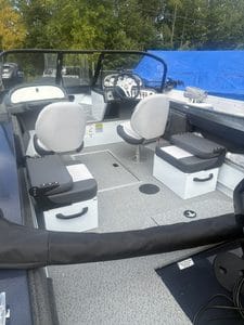 Interior view of a Smoker Craft 162 Osprey boat with seating and steering console.