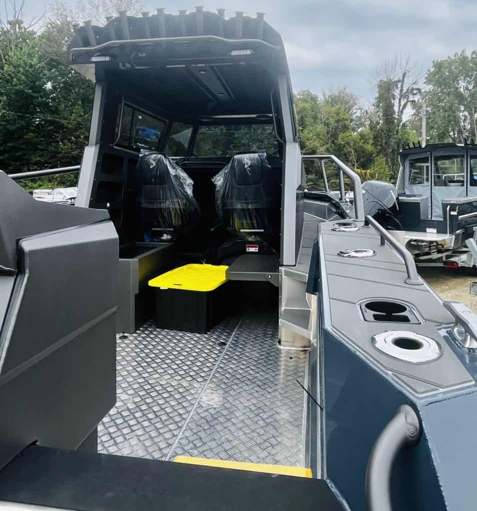 Modern marine boat with seating and control area for camping and cruising.