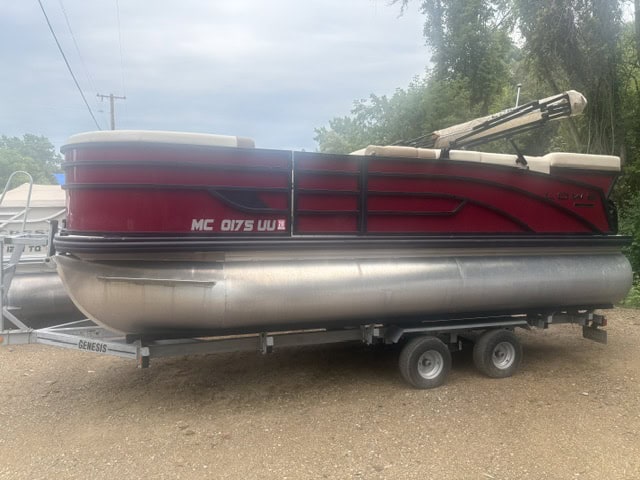 Red Lowe SS190 pontoon boat on trailer ready for water.