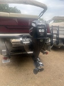 Mercury 60 HP outboard motor attached to boat for fishing or water sports.