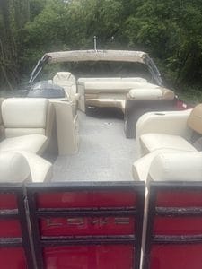 Lowe SS190 pontoon boat cruising on water with seating area.