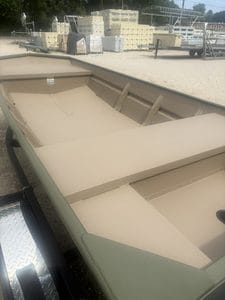 Aluminum fishing boat with spacious interior and seating for anglers.