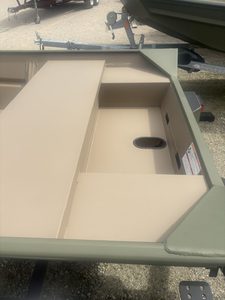 Open boat storage compartment on a SeaArk 1448 MV boat for fishing or recreation.