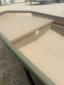 Close-up of the beige boat deck with storage compartment and seating area.