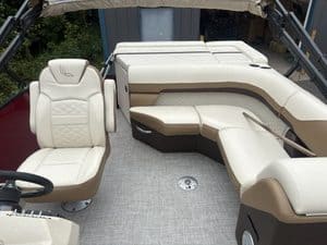 Comfortable beige and brown pontoon boat seating with spacious layout.