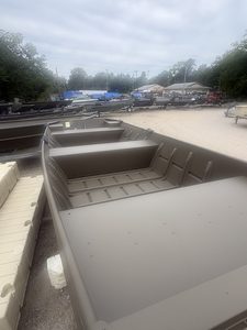 Multiple Jon boats on display at Camp & Cruise boat dealership.