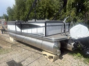 Lowe LS210 pontoon boat with outboard motor and safety railing.