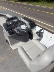 Golf cart dashboard with steering wheel and controls for outdoor use.