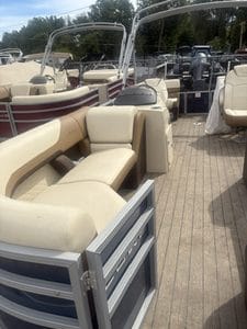 Lowe SS210 walk-thru pontoon boat with beige seating and wooden deck.