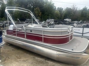 Lowe UC200 cruise pontoon boat with red and white design on display.
