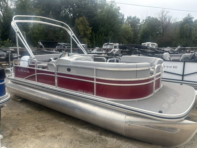 Lowe UC200 cruise pontoon boat with red and white design on display.