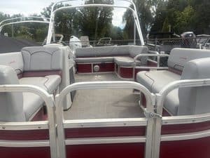 Lowe UC200 cruise pontoon boat interior with seating and steering area.