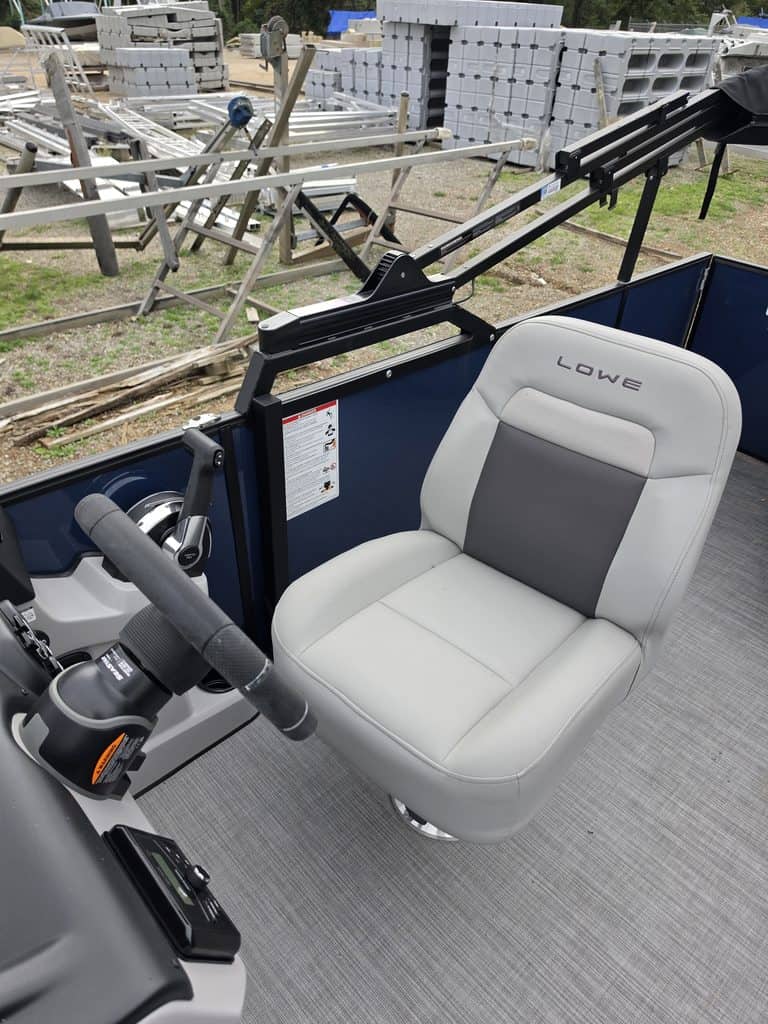 Close-up of boat captain's seat in Lowe LS 210 Tri-Toon with Mercury engine.
