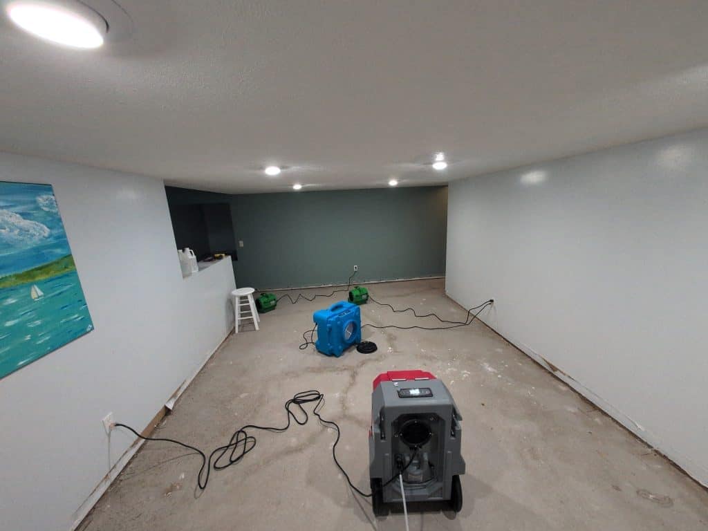 Water extraction equipment in a cleaned carpeted basement.