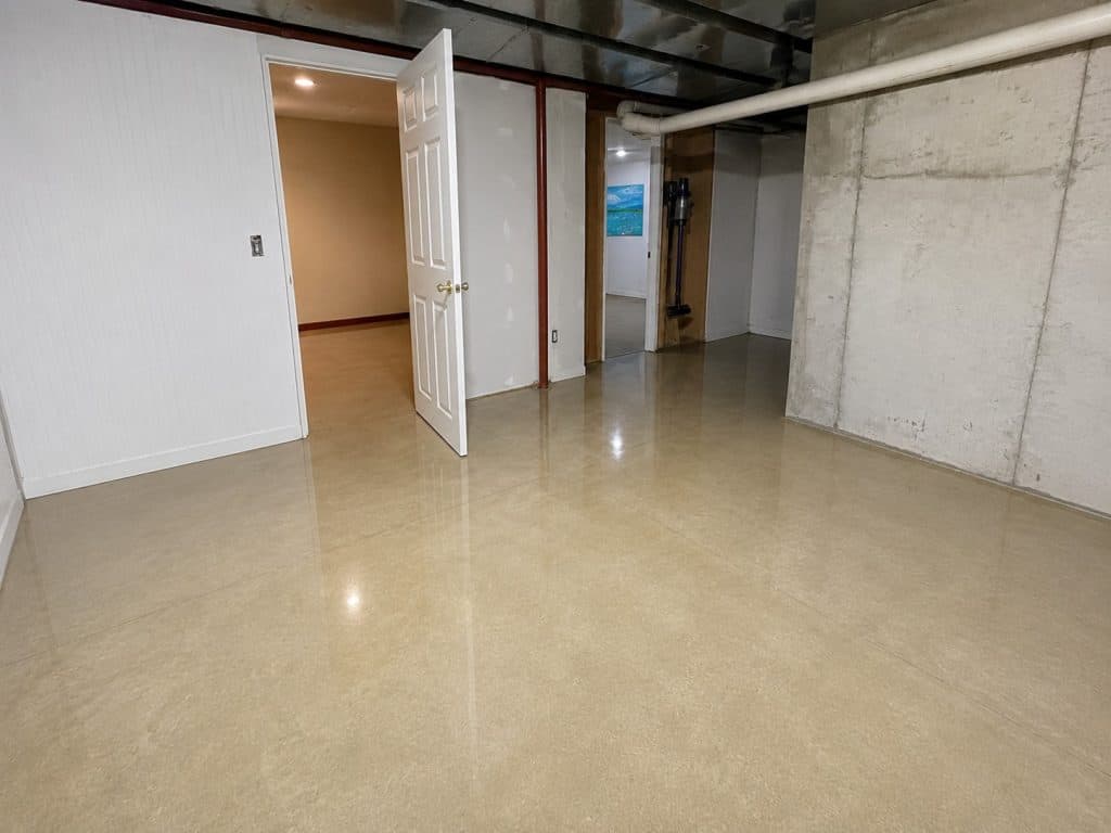 Clean basement after water extraction with dry, polished concrete floor.