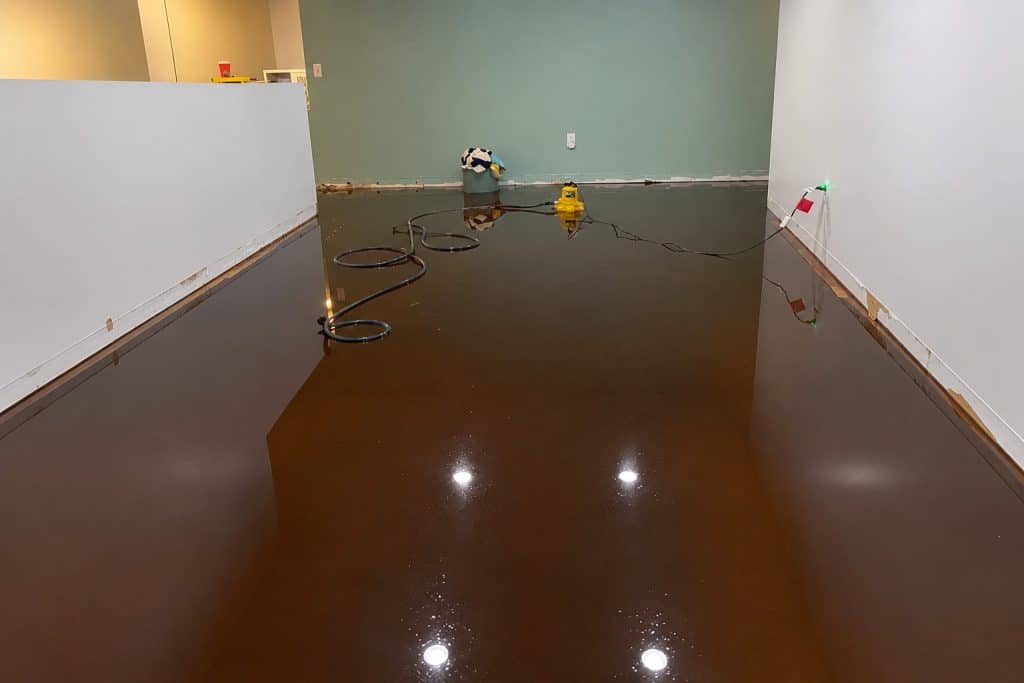 Commercial water extraction process with equipment on a flooded floor.