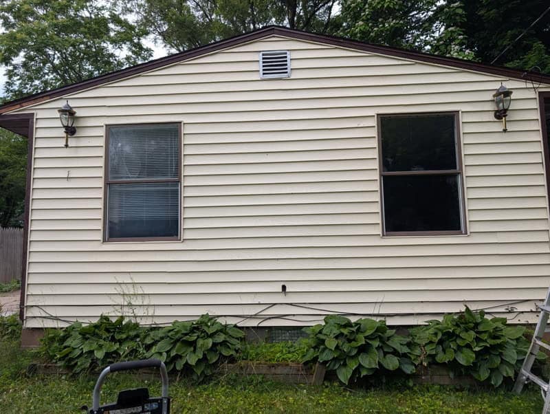 Cleaned house siding with power washing for exterior cleaning services.