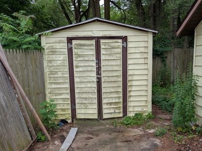 Cleaned garden shed with power washing for exterior cleaning.
