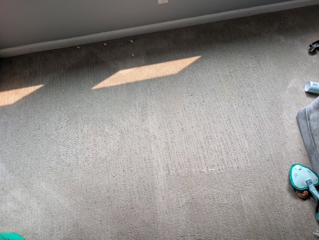 Dirty carpet with visible stains and dirt in a home interior.