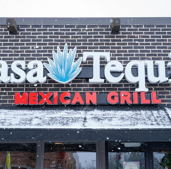 Casa Tequila Mexican Grill & Cantina sign on brick wall in Chicago.