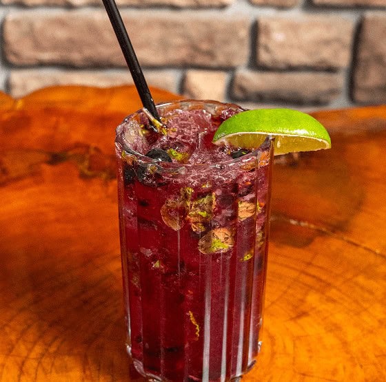 Refreshing Berry Lime Cocktail with Ice and Lime Garnish.