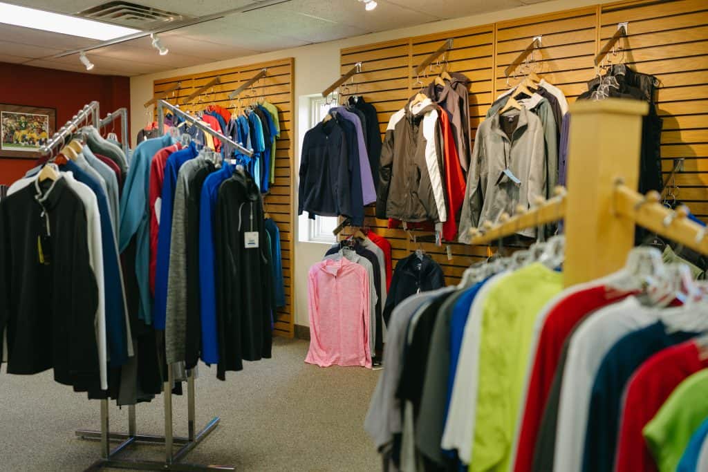 Clothing store interior with racks of colorful apparel for website redesign.