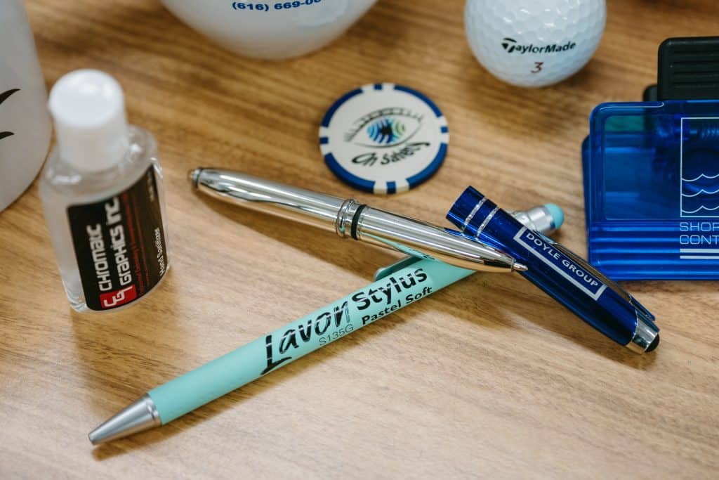 Pen, golf balls, and branding tools for website renaming project.