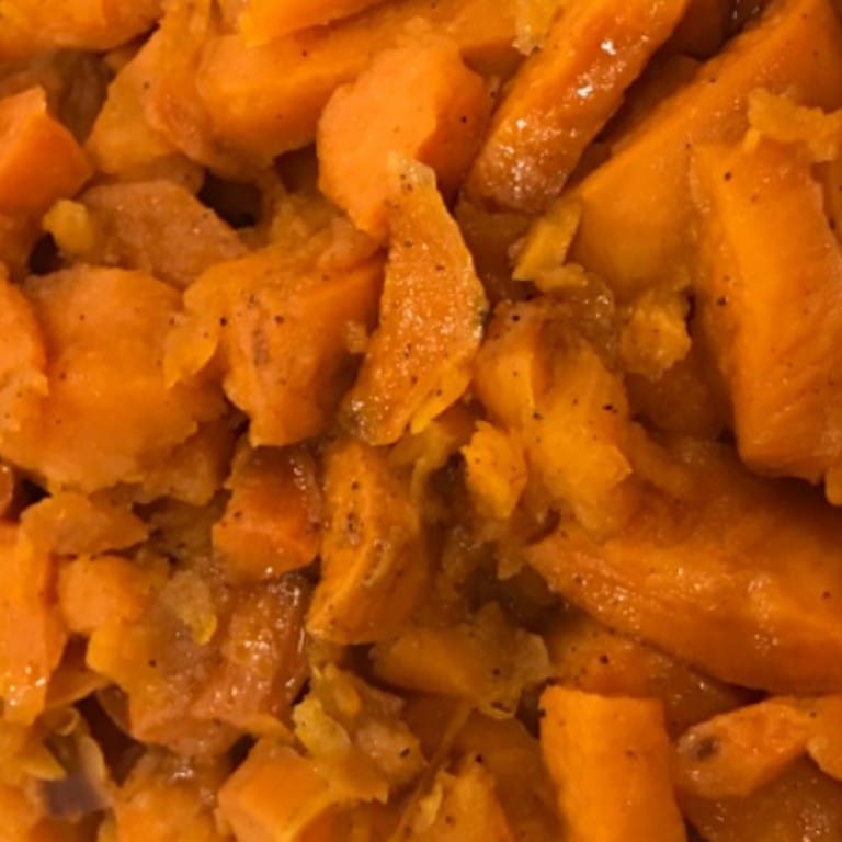 Close-up of glazed candied yams with caramelized edges, highlighting their tender texture and sweet flavor, perfect for traditional soul food meals.