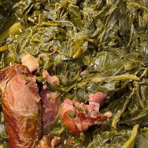 Traditional Southern collard greens cooked with ham hock, served as a flavorful side dish.