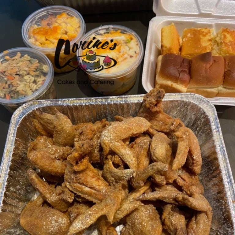Delicious family meal featuring crispy fried chicken, cornbread, macaroni and cheese, and sweet desserts, perfect for sharing with loved ones.