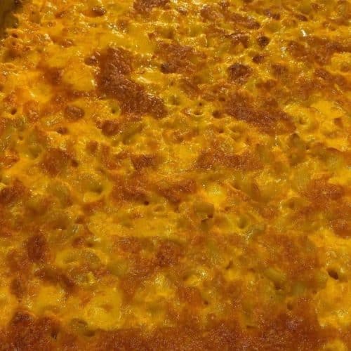 Delicious baked macaroni and cheese featuring creamy cheese sauce and golden crispy topping, perfect for soul food lovers and catering events.
