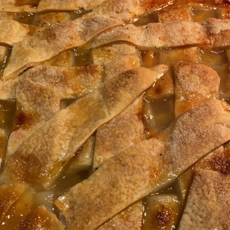 Peach cobbler with golden, flaky crust and sweet, juicy peach filling, perfect for comfort food lovers. Freshly baked and served warm, ideal for family gatherings and special occasions.