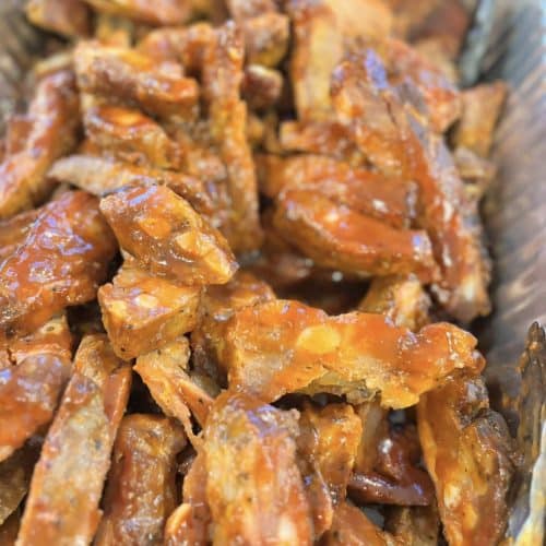 Delicious smoked rib tips glazed with savory barbecue sauce, perfect for a hearty meal or catering event. Freshly prepared at Corine's Soul Food, Cakes & Catering.