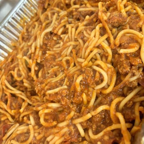 Delicious spaghetti topped with savory meat sauce, perfect for a hearty meal from Corine's Soul Food, Cakes & Catering.