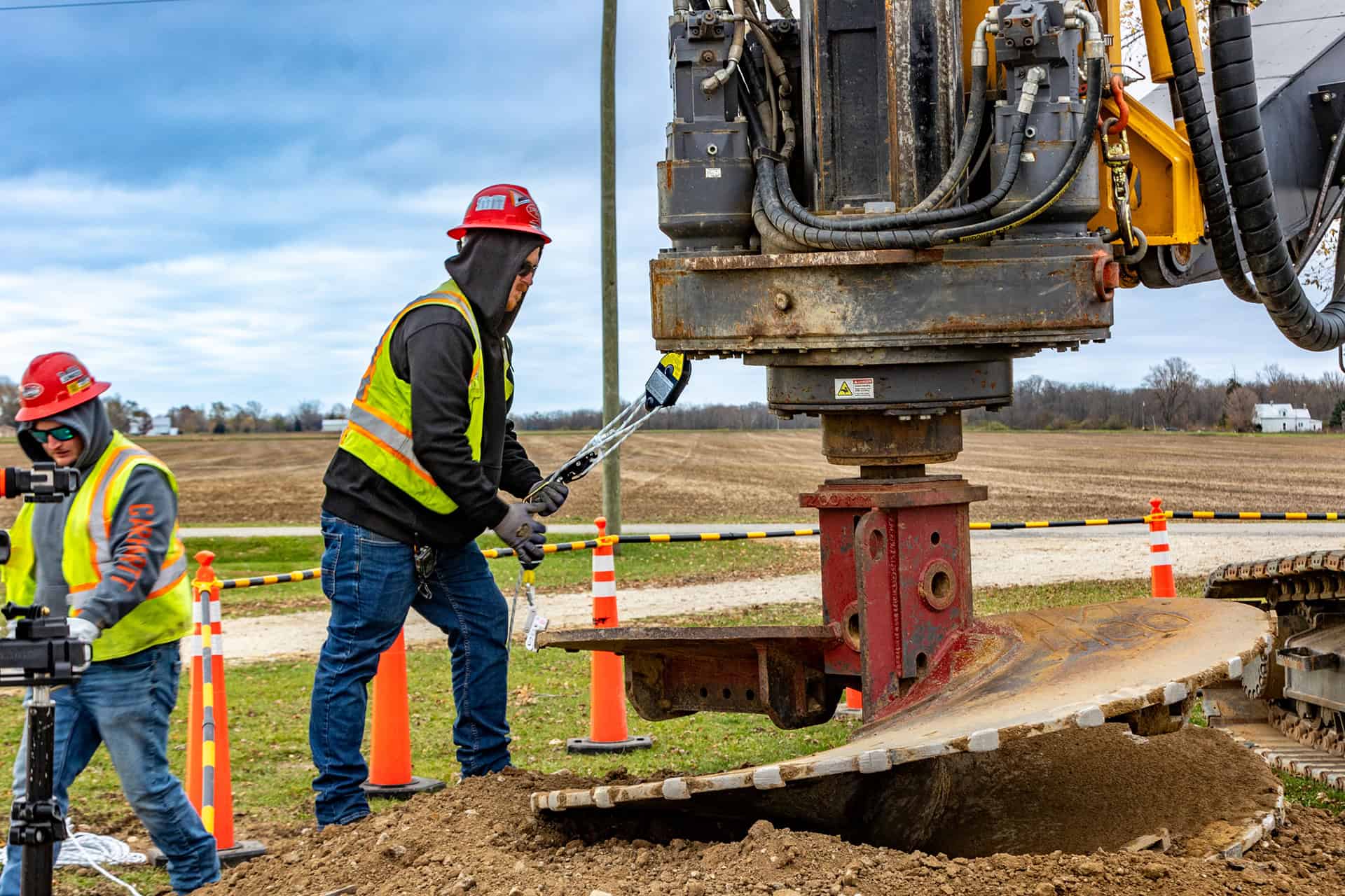 Construction workers operating heavy machinery on a construction site.