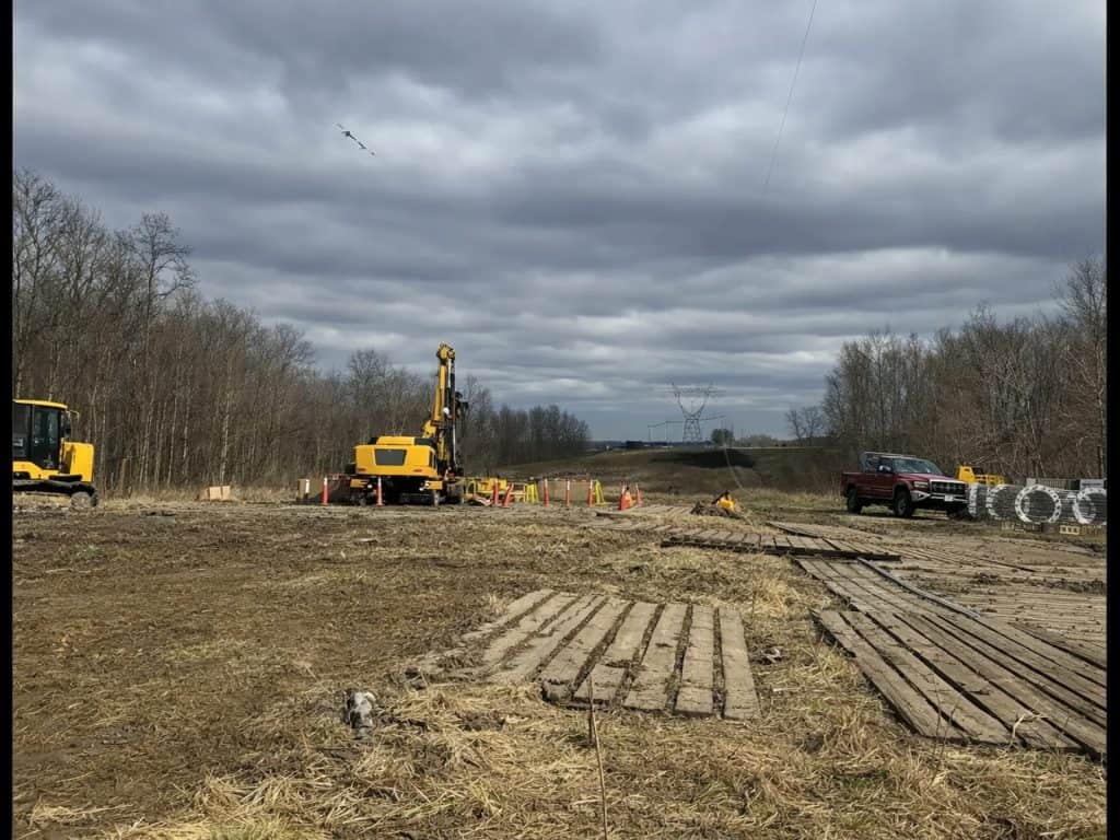 Storm damage repair work on high-voltage power lines in progress. Heavy machinery and construction c.