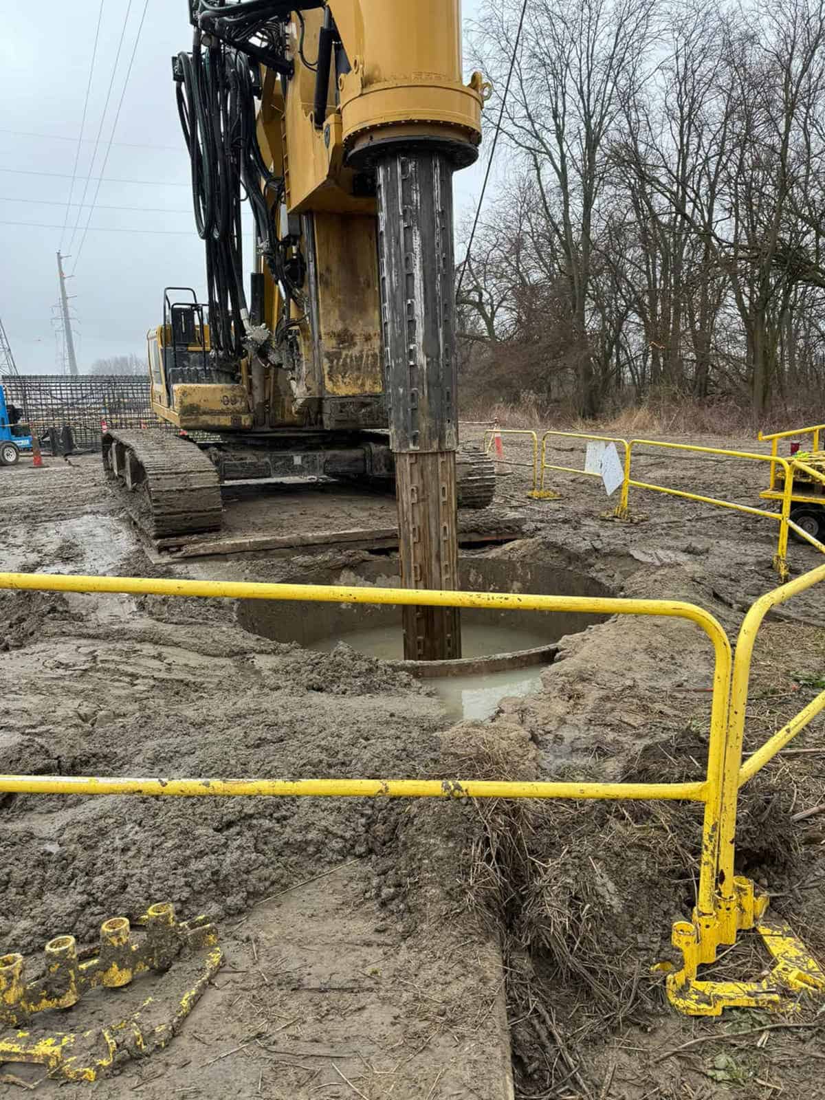 Heavy-duty foundation drilling machine performing deep soil stabilization in Indiana.