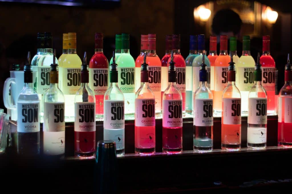 Colorful vodka bottles illuminated at Dublin Square bar in Lansing.