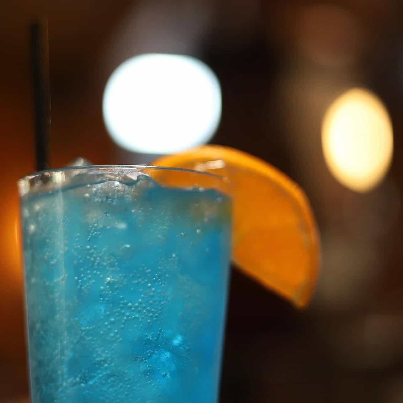 Blue cocktail with orange slice at Dublin Square in Lansing.