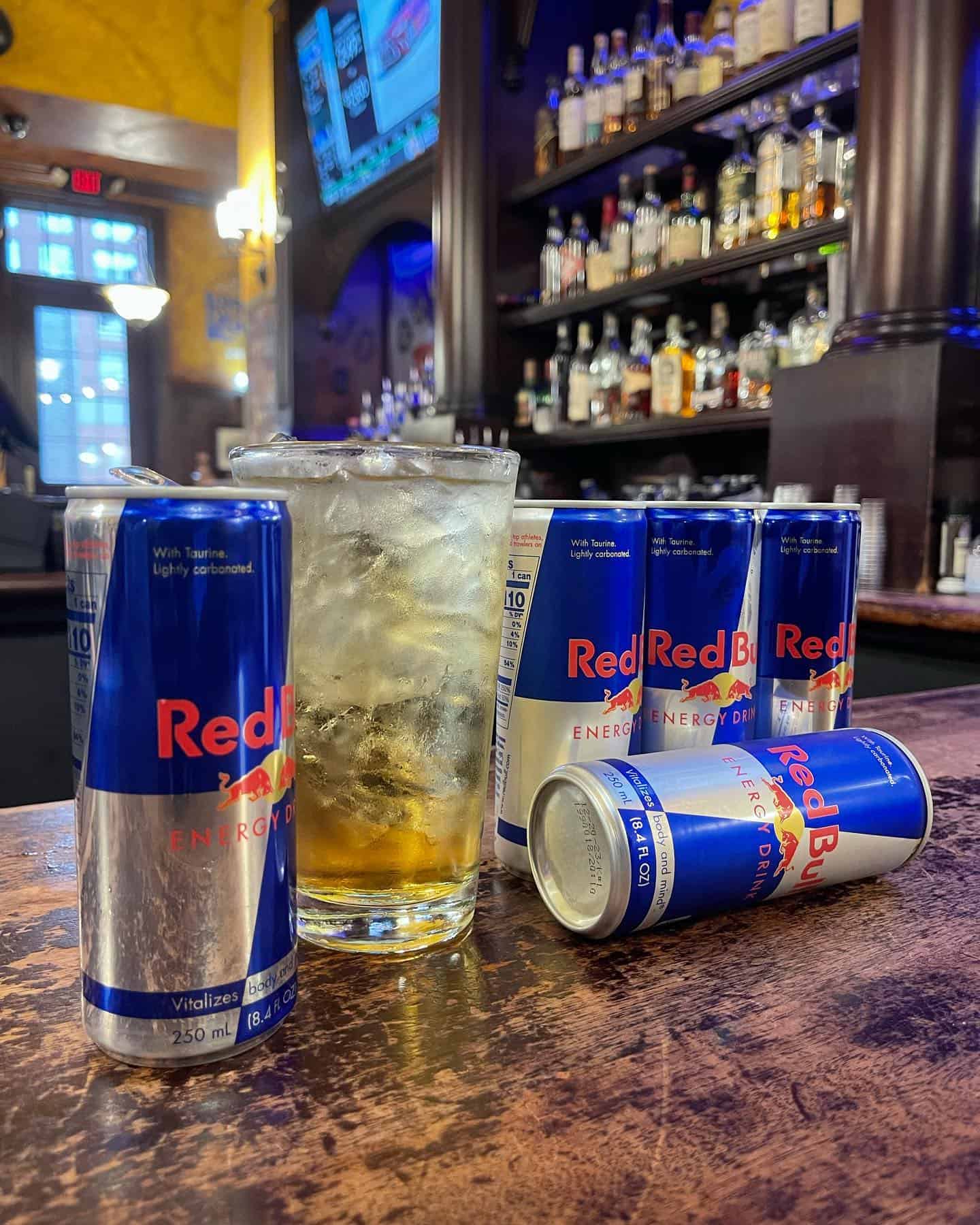Red Bull energy drinks and a glass of whiskey on bar counter at Dublin Square.